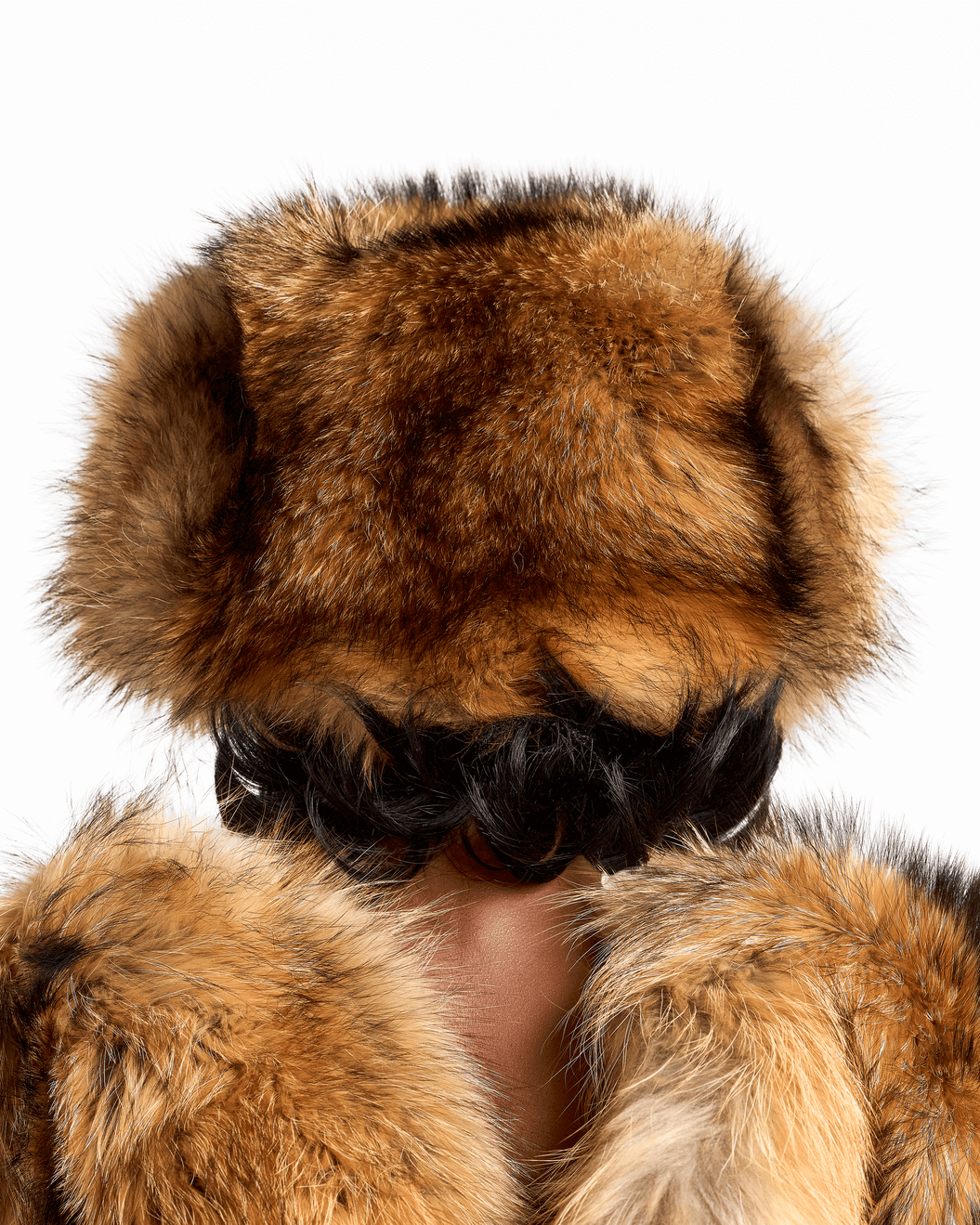 Back view of a model wearing a luxurious light brown and black fox fur halter top from the Monroe collection.